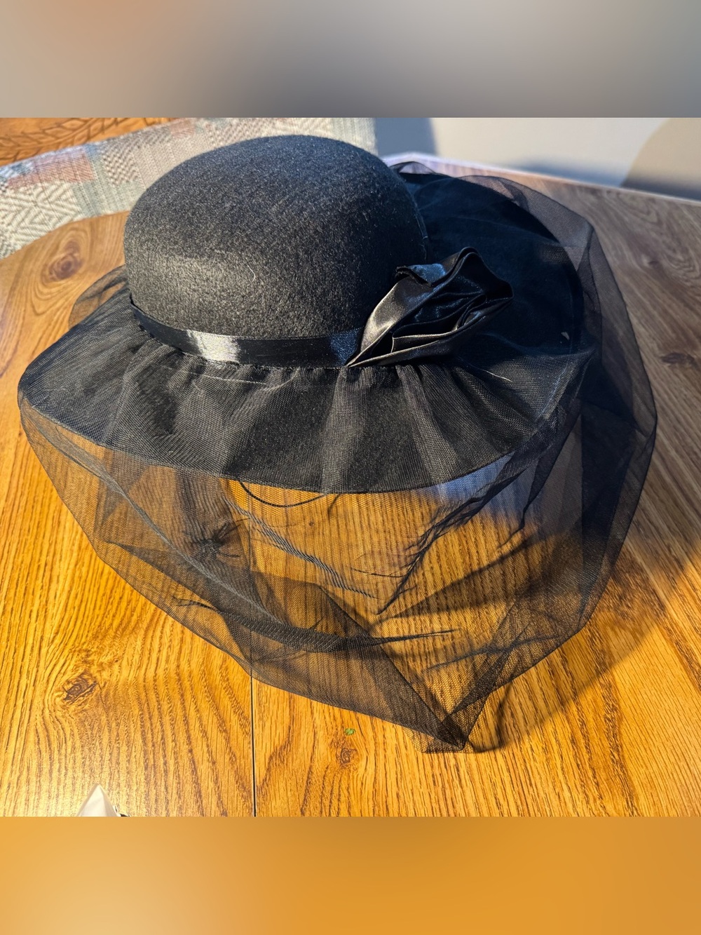 derby-style felt hat black tulle veil with spiders and a decorative satin rose